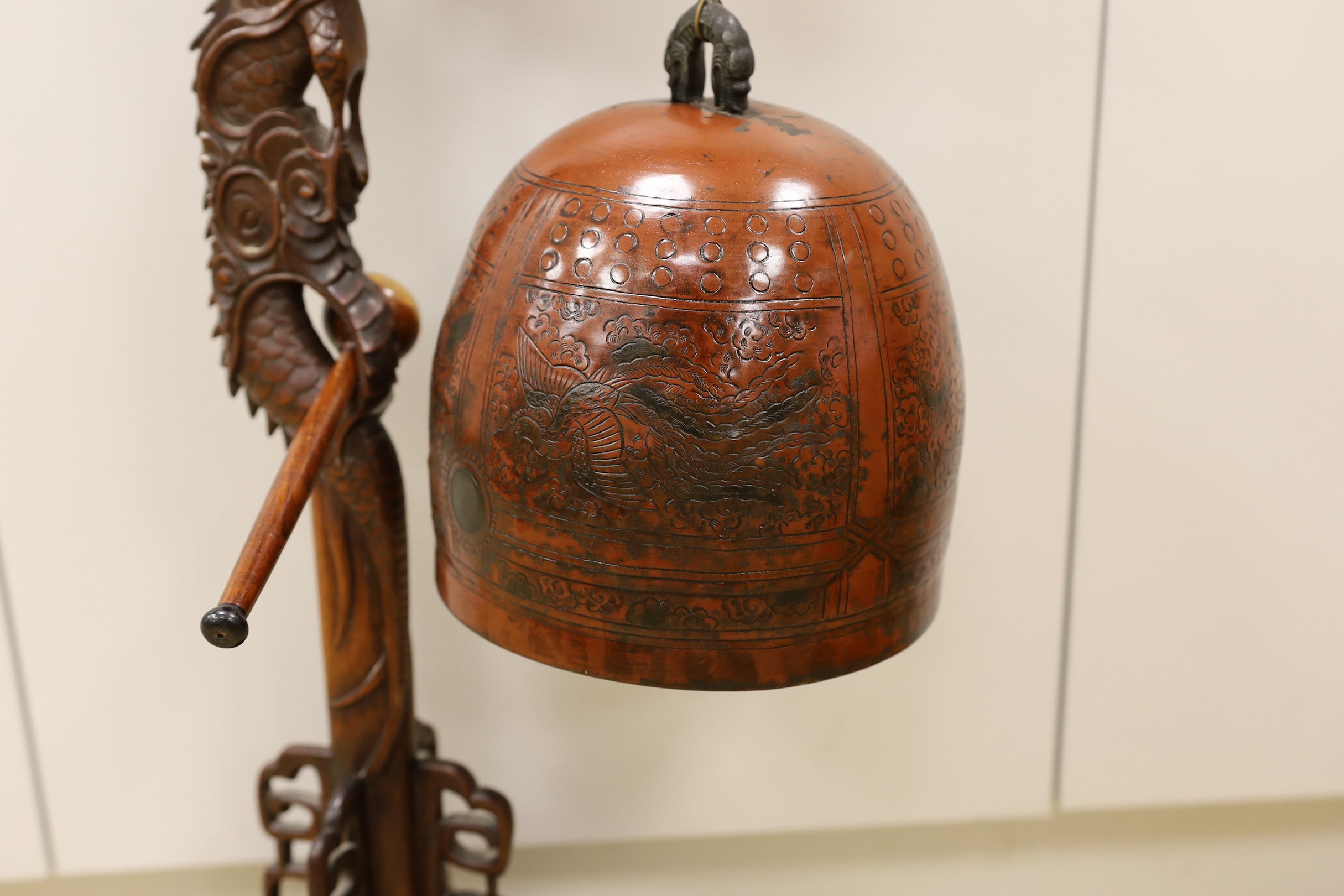 A Chinese carved hongmu 'dragon' stand with Japanese bell, 73cm tall